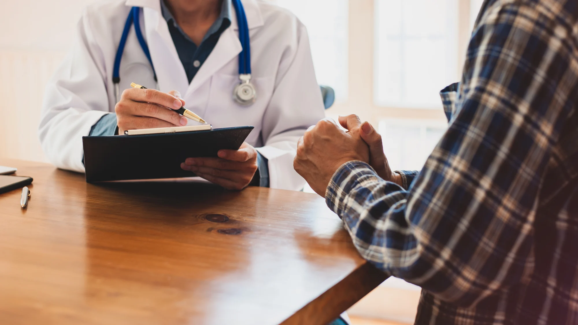 A doctor discussing treatment with a patient in a clinic setting