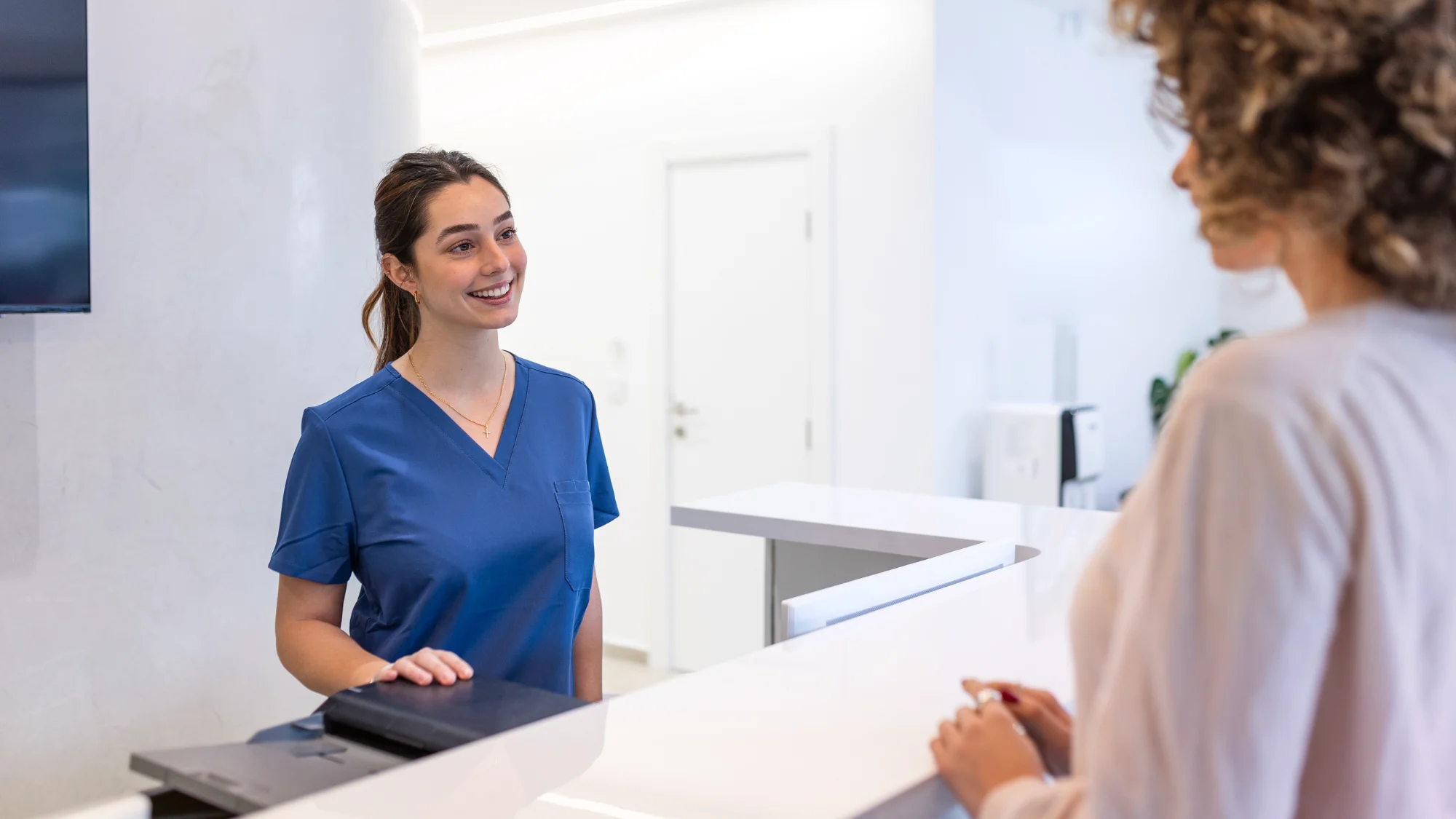 Doctors and nurses helping patients in a medical office setting